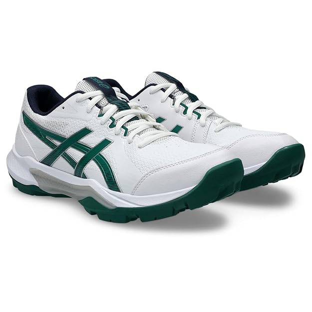 White and green athletic shoes ASICS Gel Peake 3 cricket shoes with durable rubber spikes and white synthetic upper