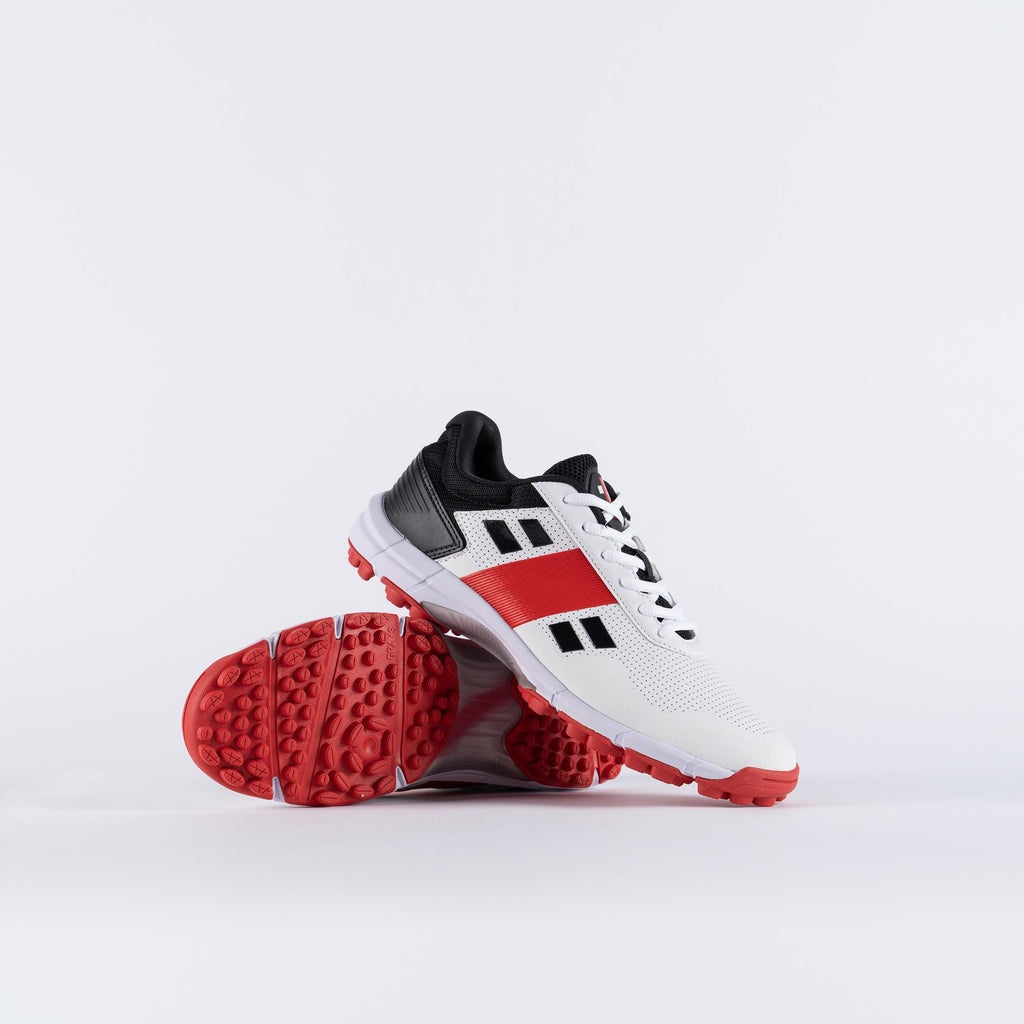 White sports shoes with red soles Gray Nicolls Velocity 4.0 cricket shoes with XTRA DURA+ rubber outsole