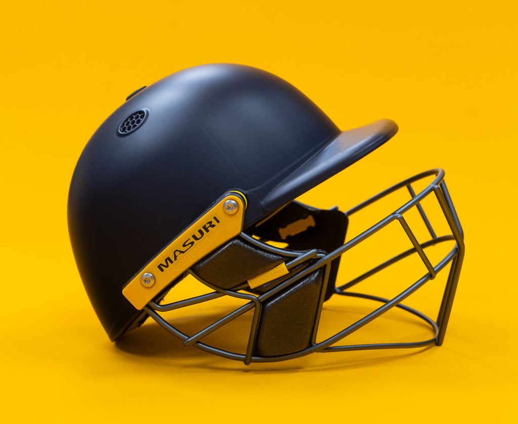 Side profile of the Masuri T Line Plus cricket helmet showing the shell and grille