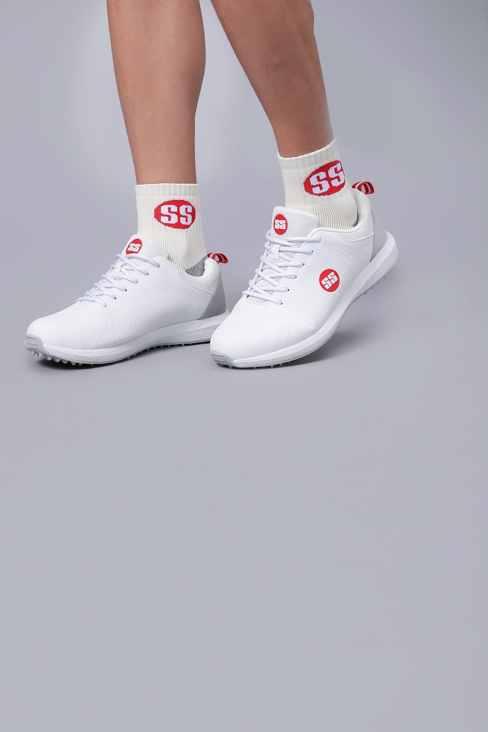White sneakers and socks with red SS cricket shoes for men with breathable synthetic leather upper
